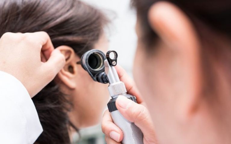 doctor is checking patient ear