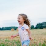 Happy child running through a field
