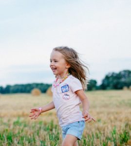 Happy child running through a field