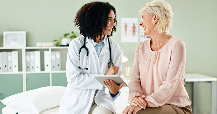 Urgent care doctor consulting an old lady