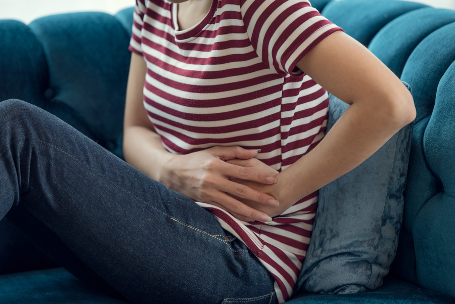 woman with stomatch ache hands touching her belly